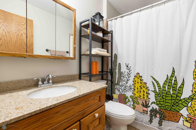 bathroom with vanity, a textured ceiling, and toilet