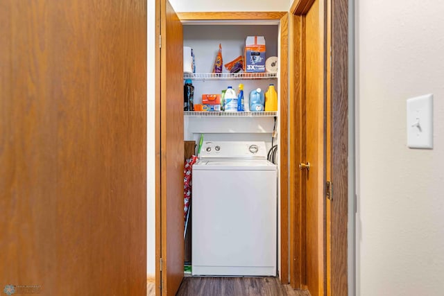 clothes washing area featuring dark hardwood / wood-style floors and washer / clothes dryer