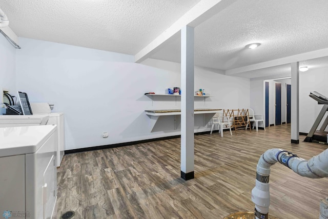 washroom with hardwood / wood-style floors, washer and dryer, and a textured ceiling