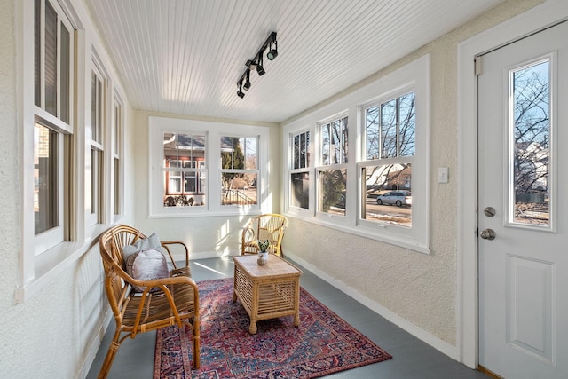 sunroom / solarium with rail lighting and wood ceiling