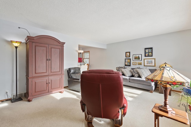 living room featuring light colored carpet and a textured ceiling