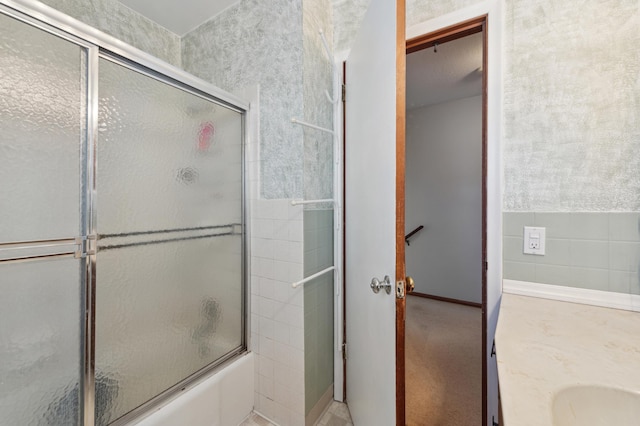 bathroom featuring vanity and shower / bath combination with glass door