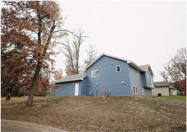 view of side of property with central air condition unit