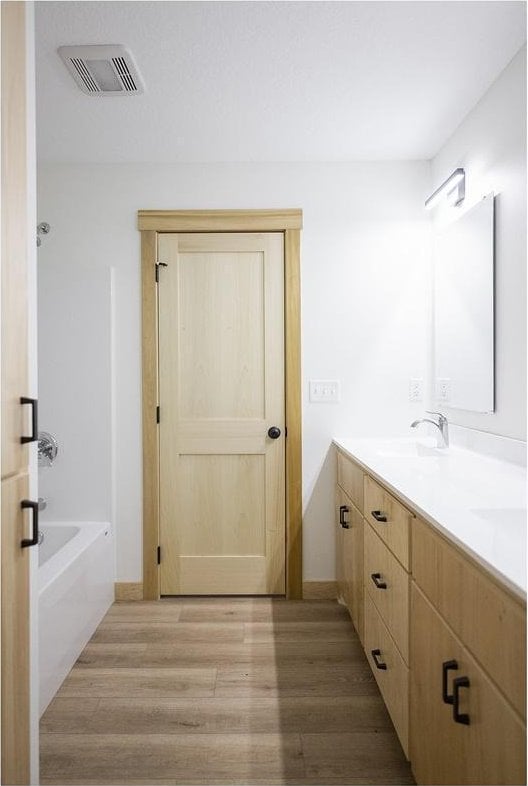 bathroom featuring hardwood / wood-style floors and vanity