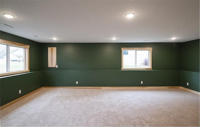 unfurnished room featuring light colored carpet