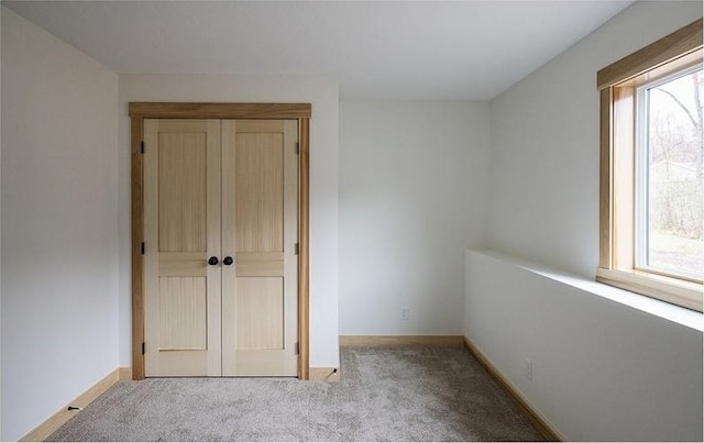 unfurnished bedroom with light carpet