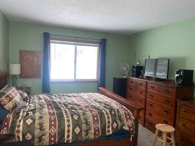 bedroom featuring carpet floors and a textured ceiling