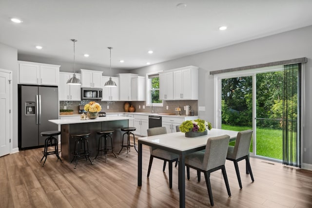 dining room featuring sink and light hardwood / wood-style flooring