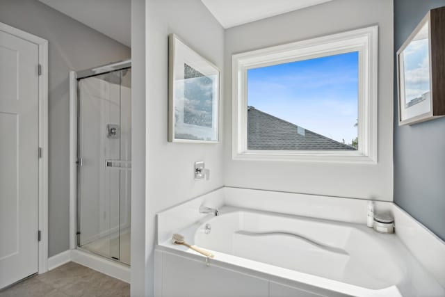 bathroom featuring separate shower and tub