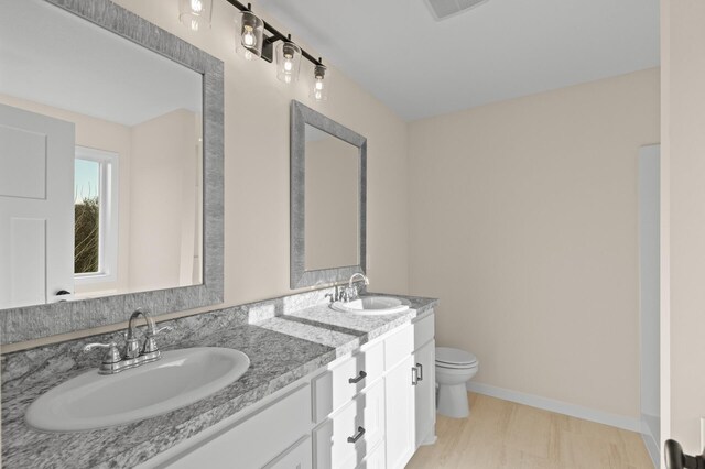 bathroom featuring hardwood / wood-style flooring, vanity, and toilet