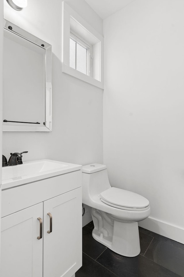 bathroom with tile patterned floors, vanity, and toilet