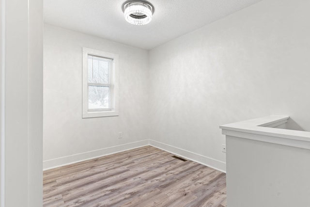 unfurnished room featuring light hardwood / wood-style floors