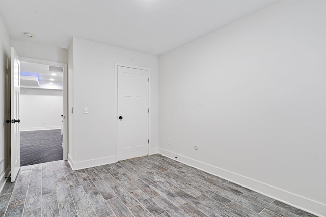 unfurnished bedroom featuring hardwood / wood-style floors and a closet