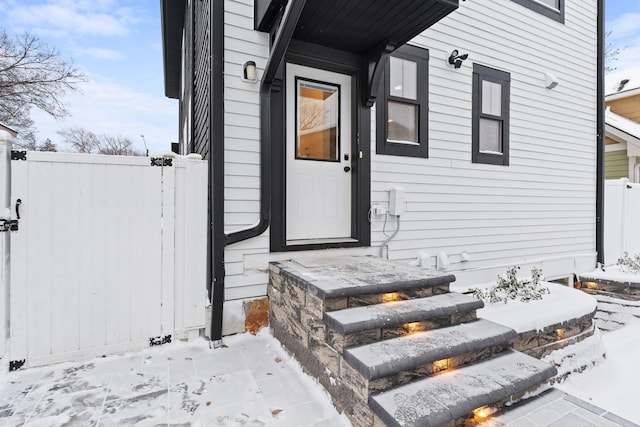 view of snow covered property entrance