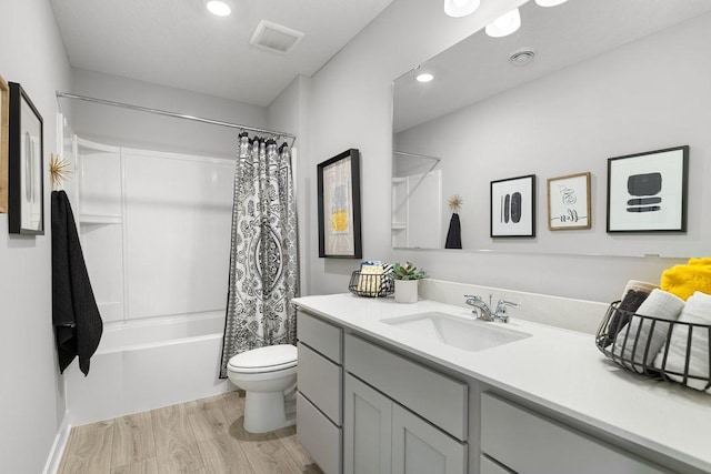 full bathroom featuring vanity, shower / bathtub combination with curtain, wood-type flooring, and toilet