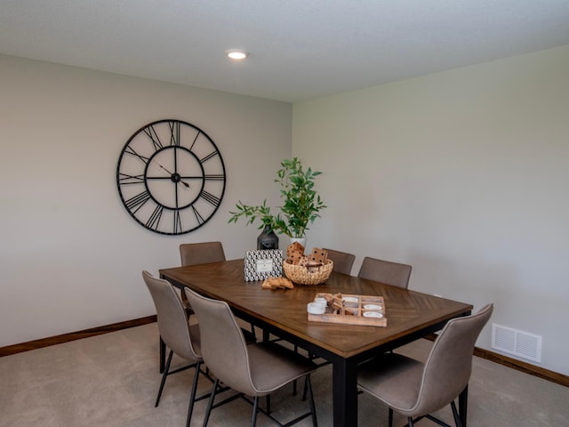 dining space with light colored carpet