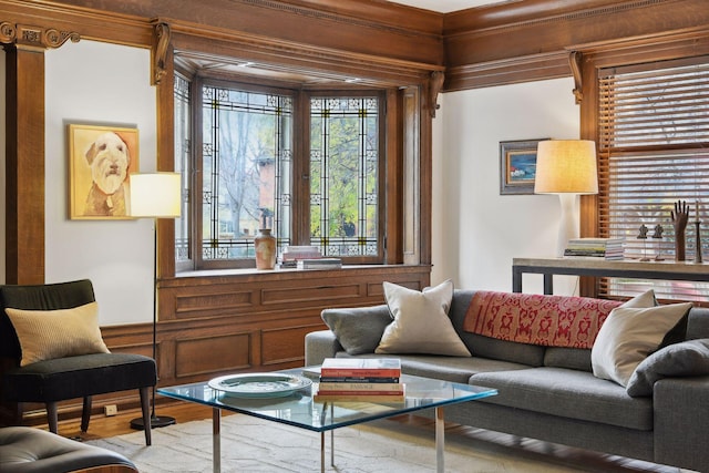 sitting room with wood-type flooring and crown molding