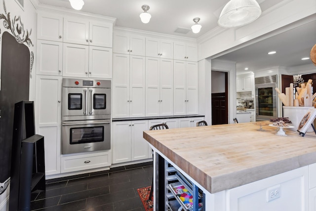 kitchen featuring white cabinets, wine cooler, crown molding, and double oven