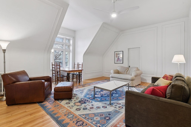 living room with ceiling fan and wood-type flooring