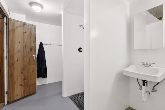 bathroom featuring concrete flooring and sink