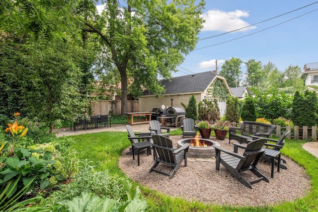 view of yard with an outdoor fire pit and a patio area