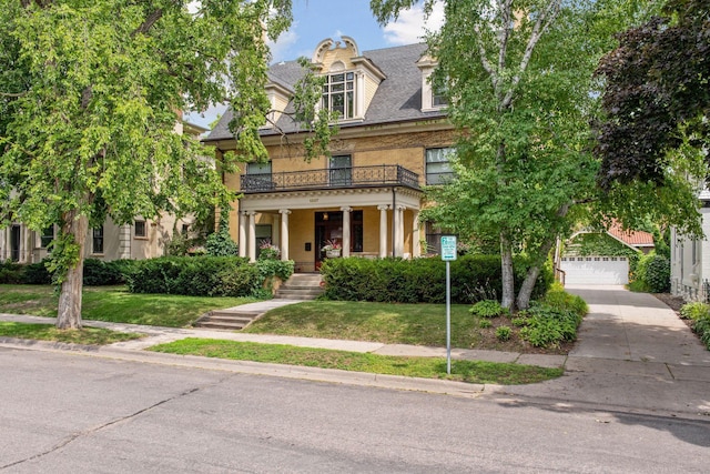 1807 Dupont Ave S, Minneapolis, MN 55403 - view of front of property featuring a balcony, a garage, a front lawn, and driveway