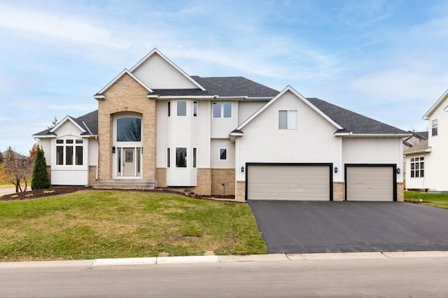 view of front facade featuring a front yard and a garage