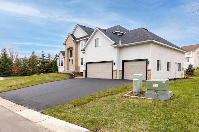 view of front of property featuring a garage and a front yard