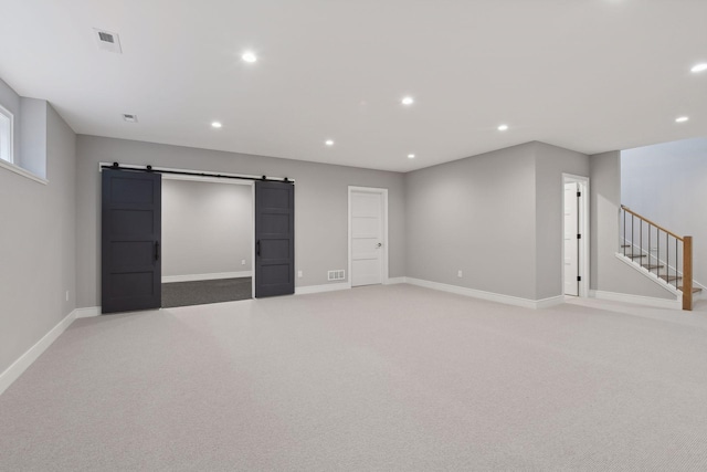 interior space featuring carpet and a barn door