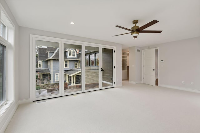 spare room featuring light colored carpet and ceiling fan