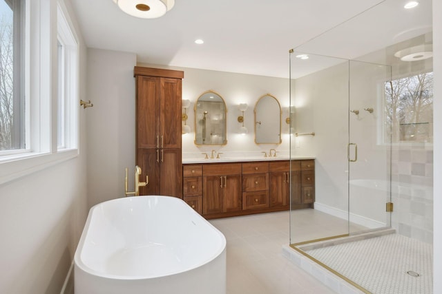 bathroom with tile patterned floors, vanity, and plus walk in shower