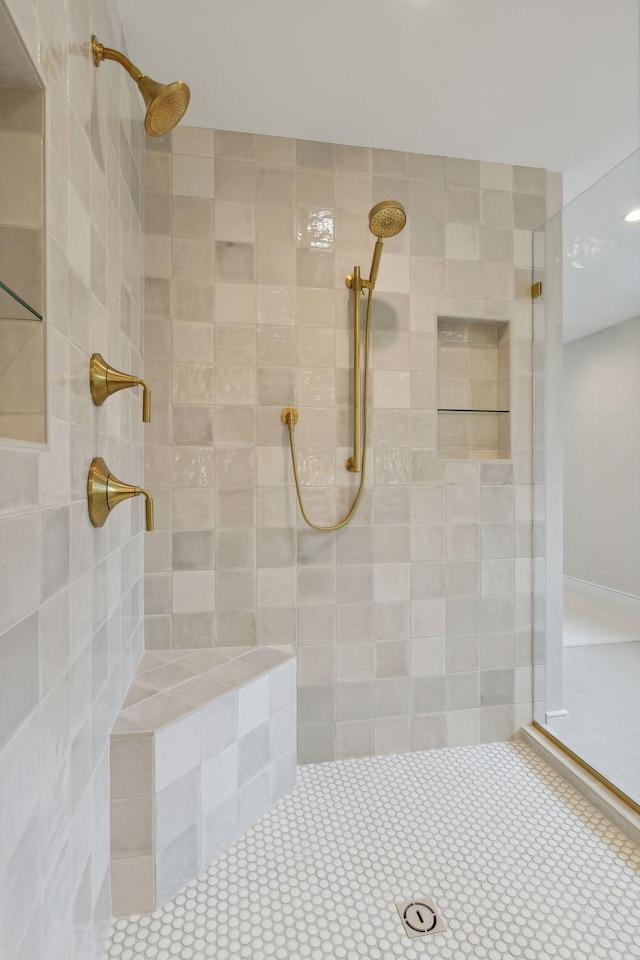 bathroom with a tile shower