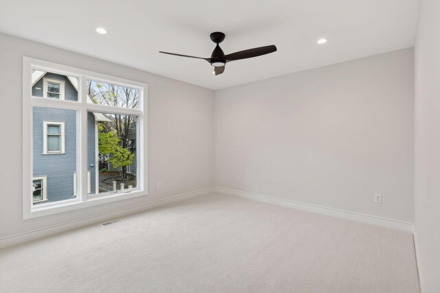 unfurnished room featuring light carpet and ceiling fan