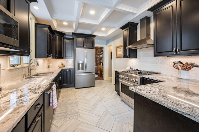 kitchen with wall chimney range hood, light stone countertops, beamed ceiling, stainless steel appliances, and a sink