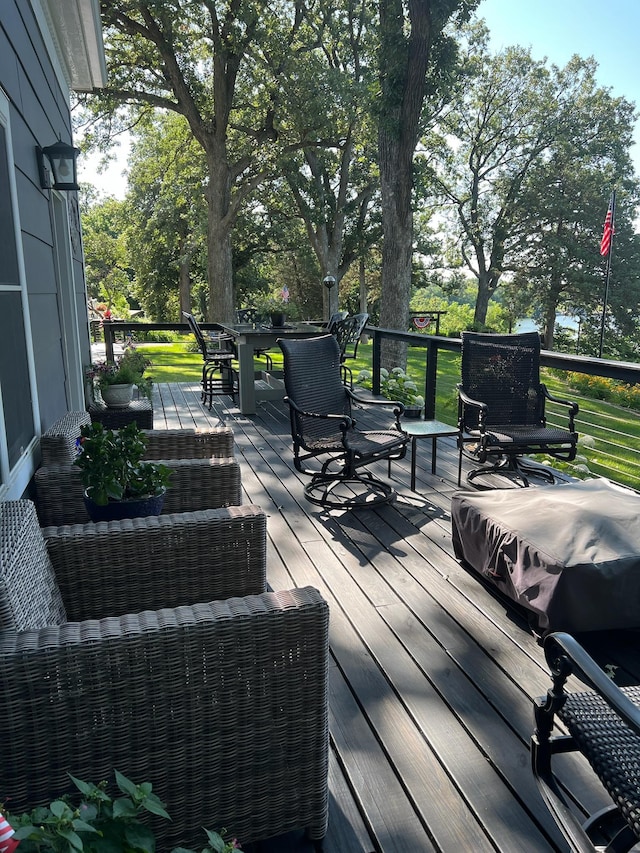 wooden terrace with outdoor dining space