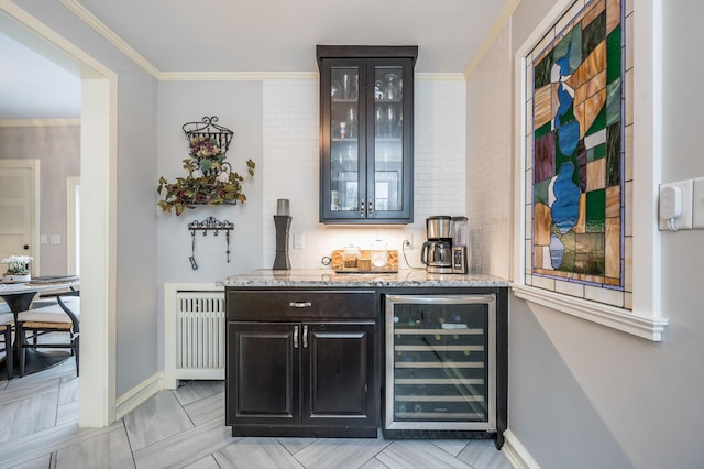 bar featuring beverage cooler, tasteful backsplash, radiator heating unit, a bar, and crown molding