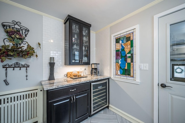 bar featuring beverage cooler, radiator heating unit, ornamental molding, decorative backsplash, and a bar