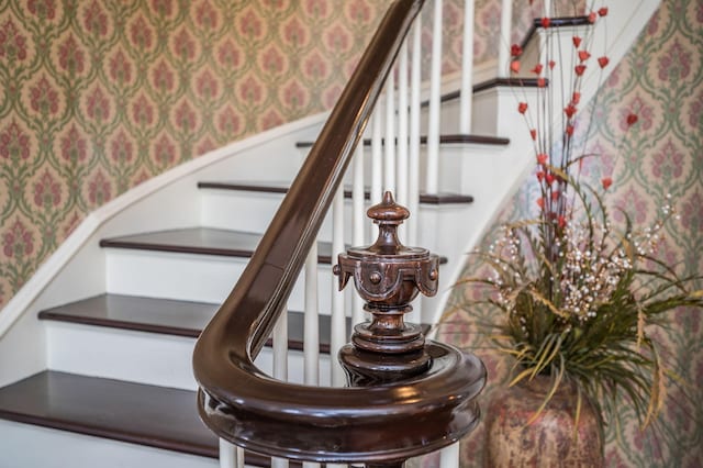 stairway with wallpapered walls