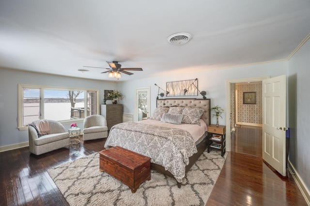 bedroom featuring visible vents, ceiling fan, baseboards, and hardwood / wood-style floors