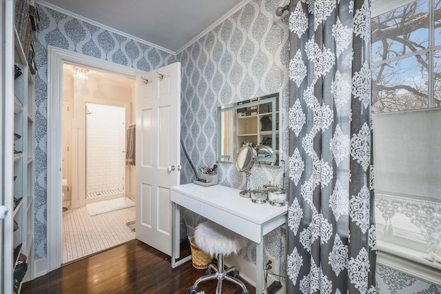 home office with wood finished floors, ornamental molding, and wallpapered walls