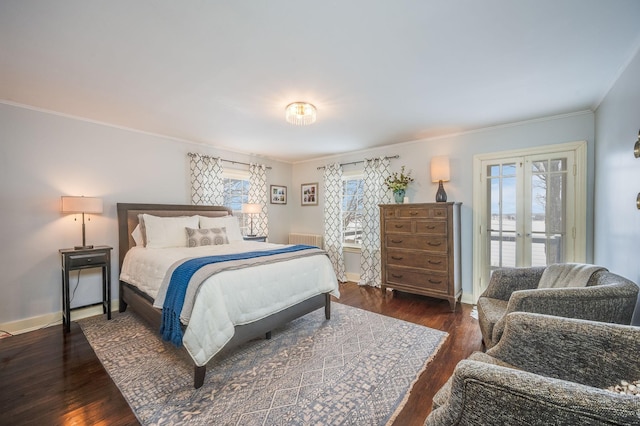 bedroom featuring dark wood-style floors, multiple windows, french doors, and access to outside