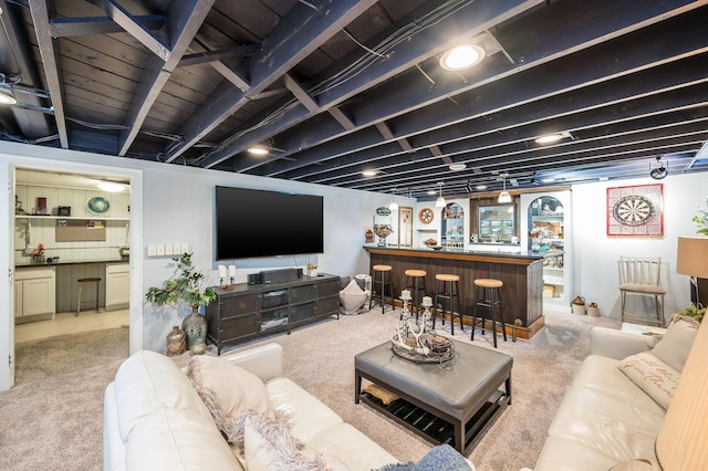 living area featuring a dry bar and carpet floors