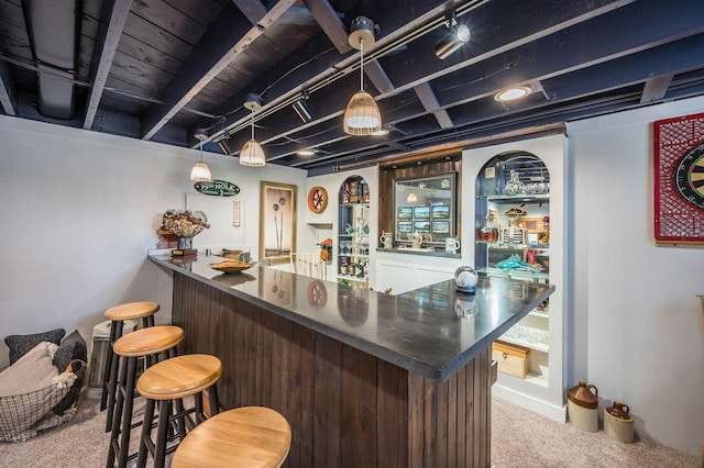 bar featuring carpet flooring, bar area, and pendant lighting