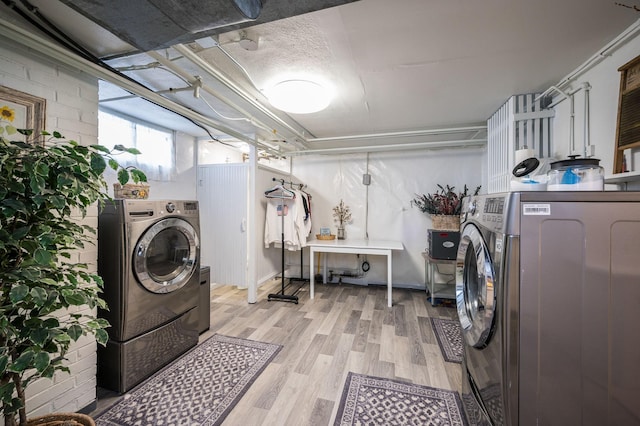 laundry area featuring light wood-style flooring and independent washer and dryer