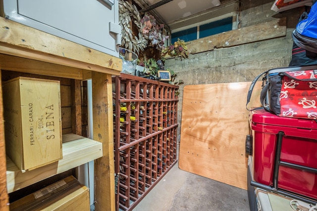 wine area featuring concrete floors