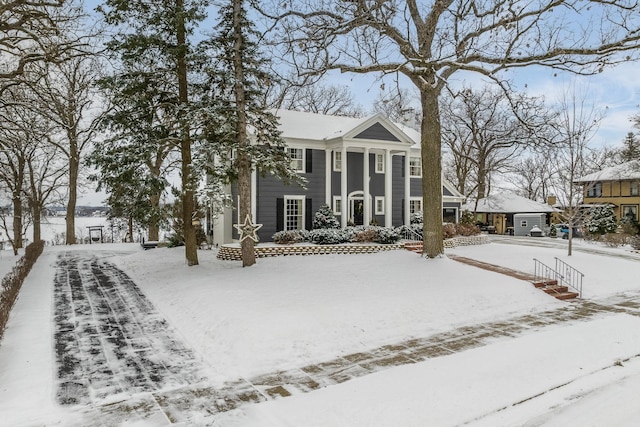 view of snow covered back of property