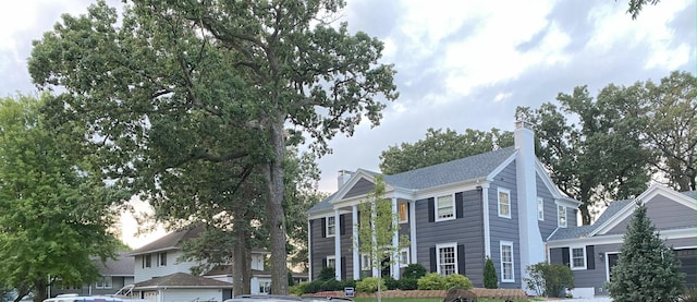 view of front facade with a chimney