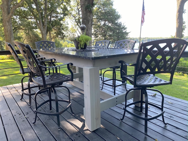 deck featuring outdoor wet bar and a yard