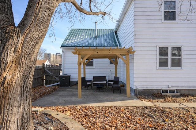 rear view of house featuring outdoor lounge area, a patio, and central AC