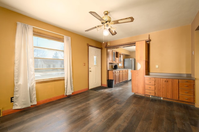 interior space featuring ceiling fan and dark hardwood / wood-style flooring